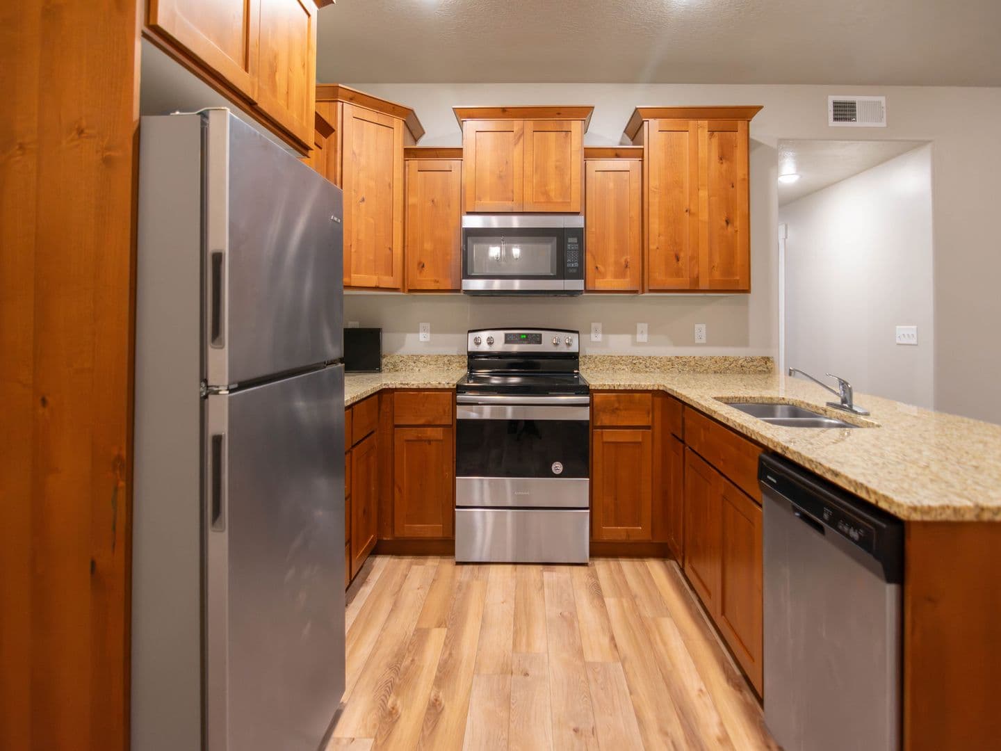 Open kitchen with granite counters and stainless steel appliances